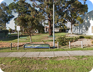 Park area with benches and trees, featuring a sign for "Yamack Reserve," illustrating community spaces in Western Sydney relevant to Ability to Achieve's service areas.