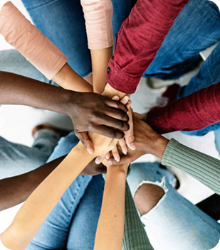 Diverse group of hands joining together in a supportive gesture, symbolising community connection and empowerment in disability support services in Parramatta.