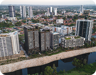 Aerial view of modern residential buildings along a river in a city, showcasing urban development in Western Sydney, relevant to Ability to Achieve's service areas.