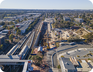 Aerial view of a construction site near a train station in Western Sydney, showcasing ongoing development and urban infrastructure, relevant to Ability to Achieve's service areas.