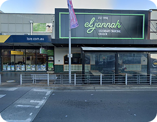 Restaurant exterior featuring Eljannah Legendary Charcoal Chicken sign, adjacent to a takeaway shop, located in a service area relevant to Ability to Achieve's disability care in Sydney.