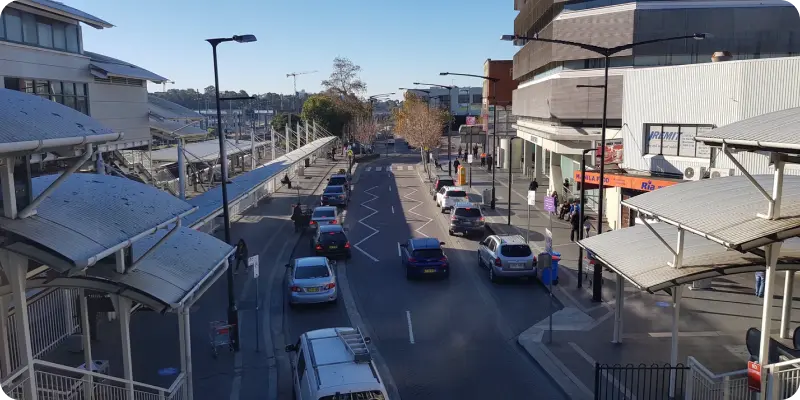 Street view of Blacktown, showcasing traffic and urban infrastructure, highlighting community engagement and accessibility in the area.